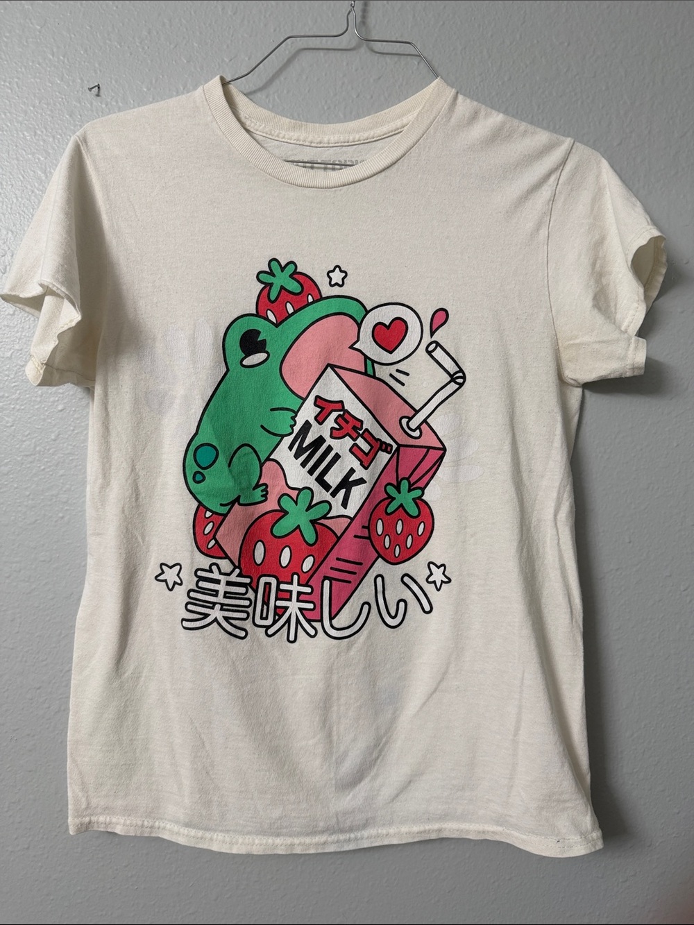 Hot Topic Cream Graphic Tee with Green Frog and Pink Strawberry Milk Design